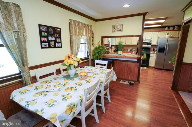 a kitchen with stainless steel appliances granite countertop a refrigerator a stove top oven a sink and dishwasher