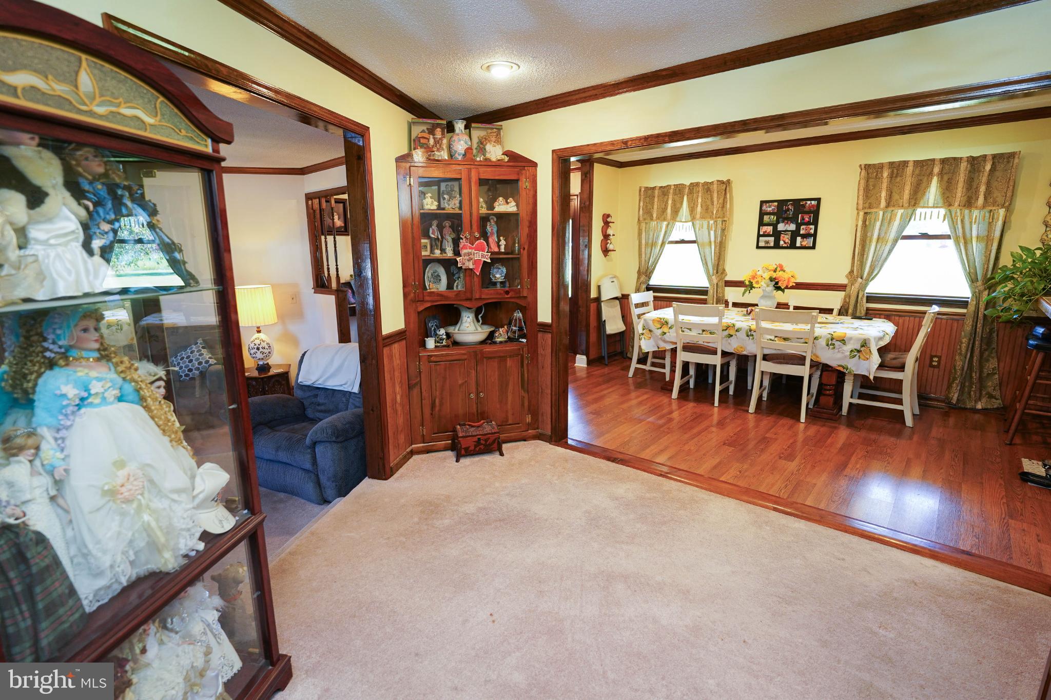 27949 Phoenix Church Road Marion Station, MD 21838 - Photo 16 of 82 a dining room with wooden floor a chandelier a glass table and chairs
