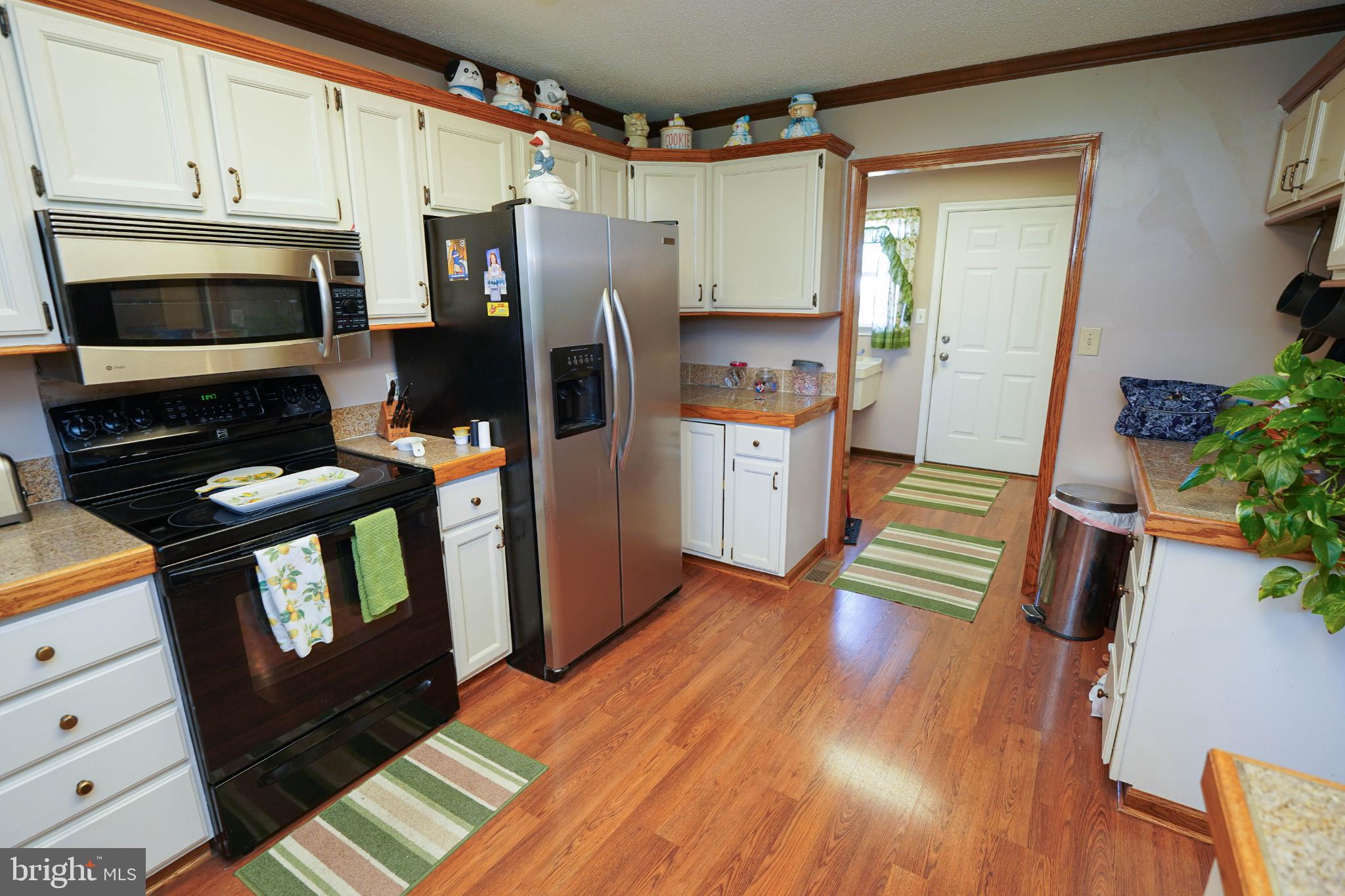 27949 Phoenix Church Road Marion Station, MD 21838 - Photo 20 of 82 a kitchen with stainless steel appliances a refrigerator sink and microwave