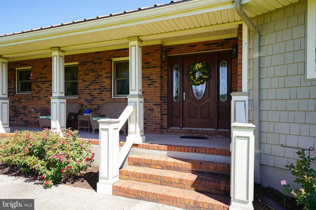 a front view of a house with potted plants