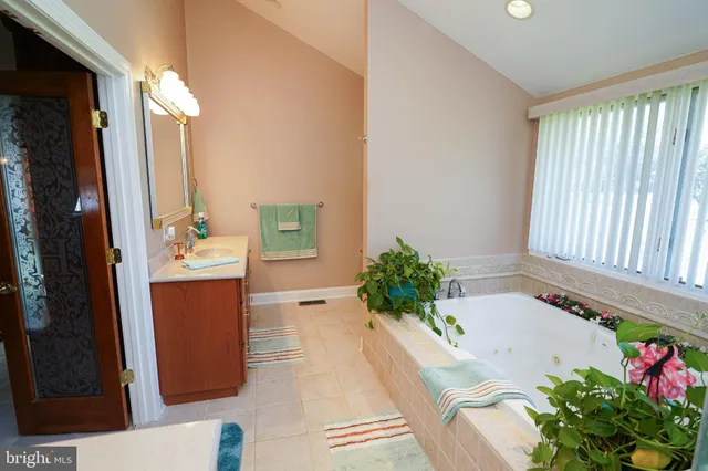 a bedroom with a dresser and a chandelier
