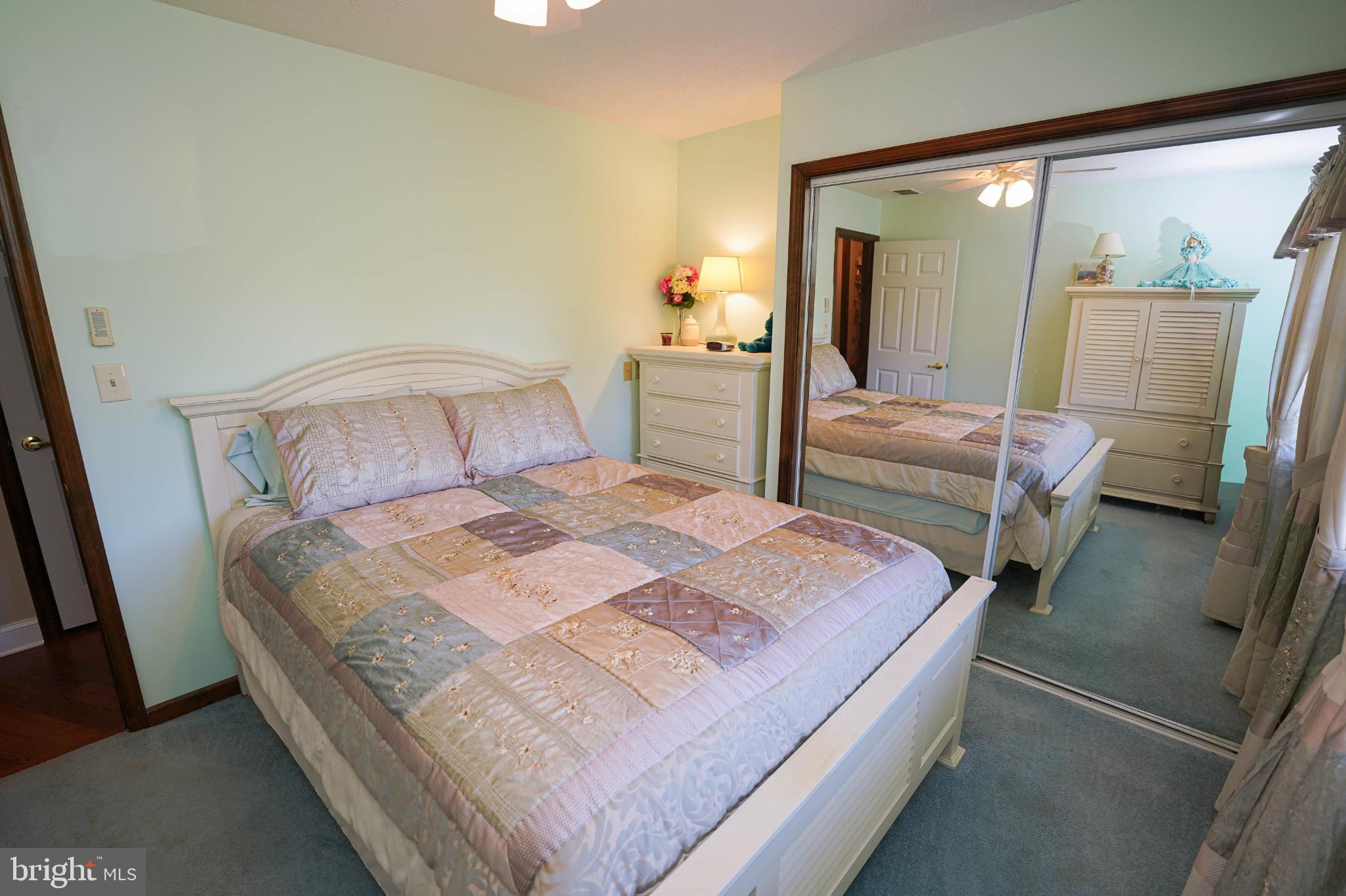 27949 Phoenix Church Road Marion Station, MD 21838 - Photo 48 of 82 Serene bedroom with mirrored elegance.