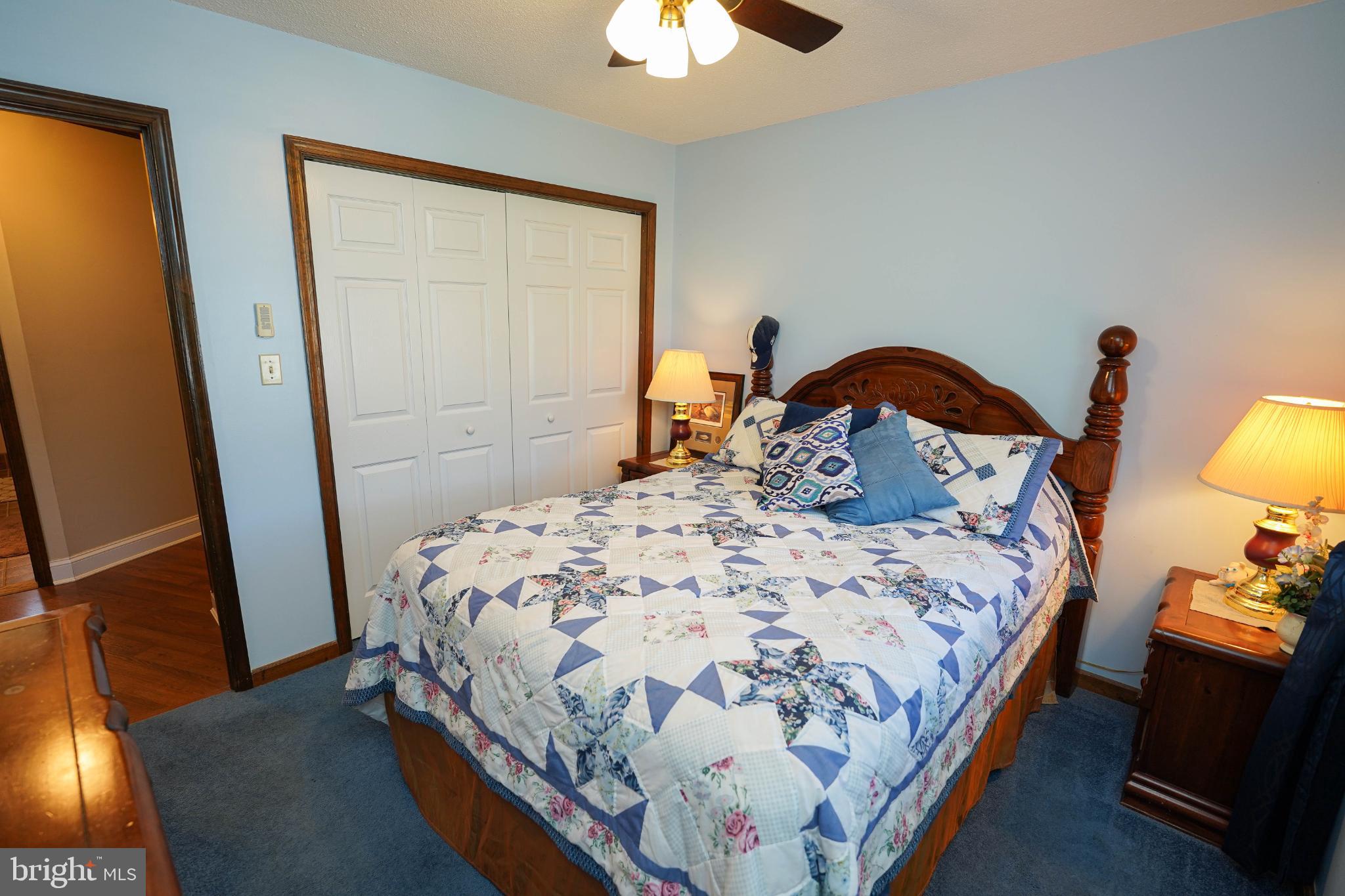 27949 Phoenix Church Road Marion Station, MD 21838 - Photo 56 of 82 a bedroom with a bed and a chandelier