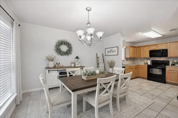 a view of a dining room with furniture and chandelier