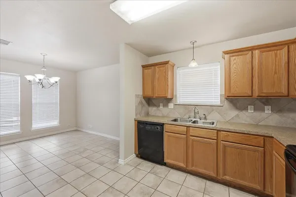 a kitchen with a sink cabinets and window