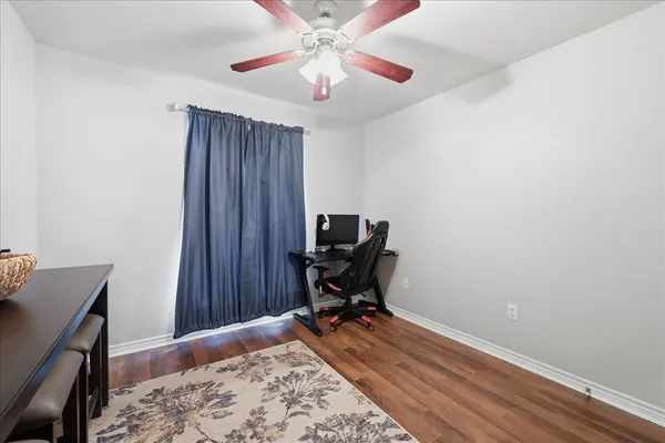 a view of a workspace with furniture and a window