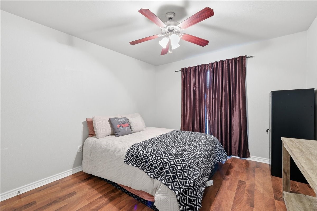 5585 Westchase Loop Lumberton, TX 77657 - Photo 8 of 13 a bedroom with a bed and wooden floor