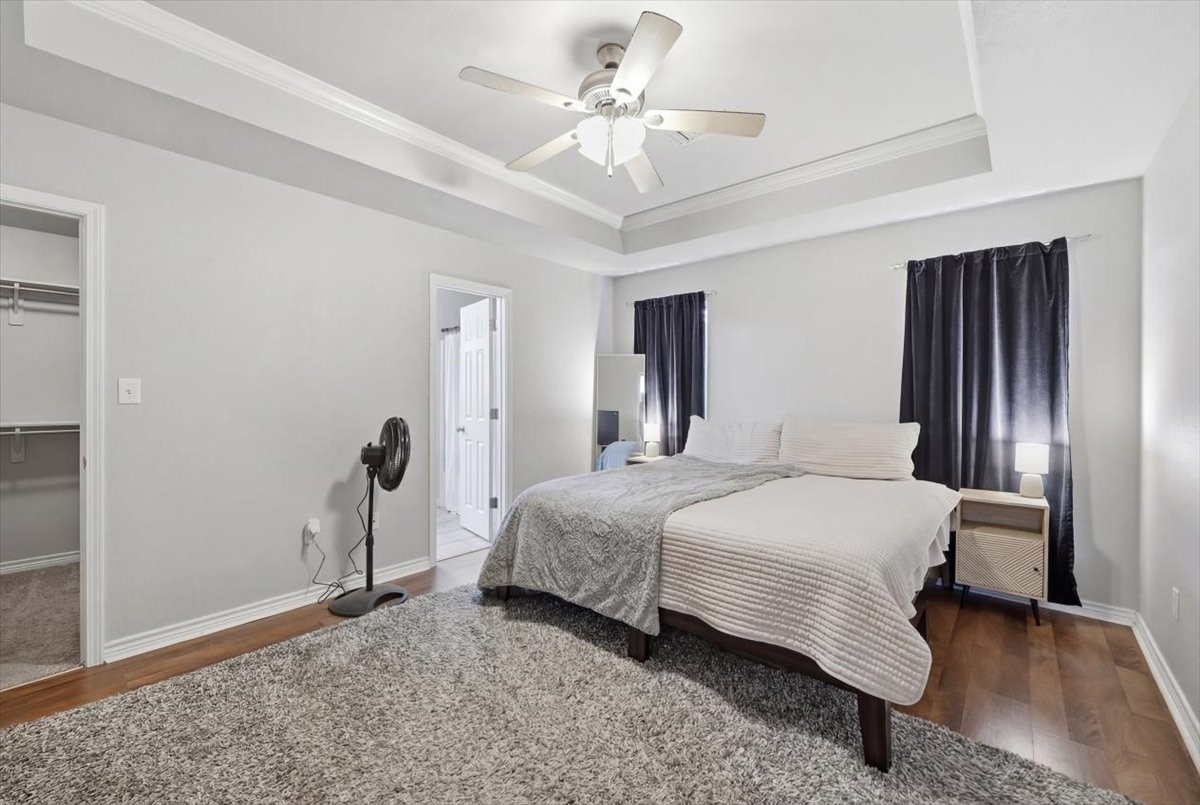 5585 Westchase Loop Lumberton, TX 77657 - Photo 10 of 13 a bedroom with a bed and a chandelier