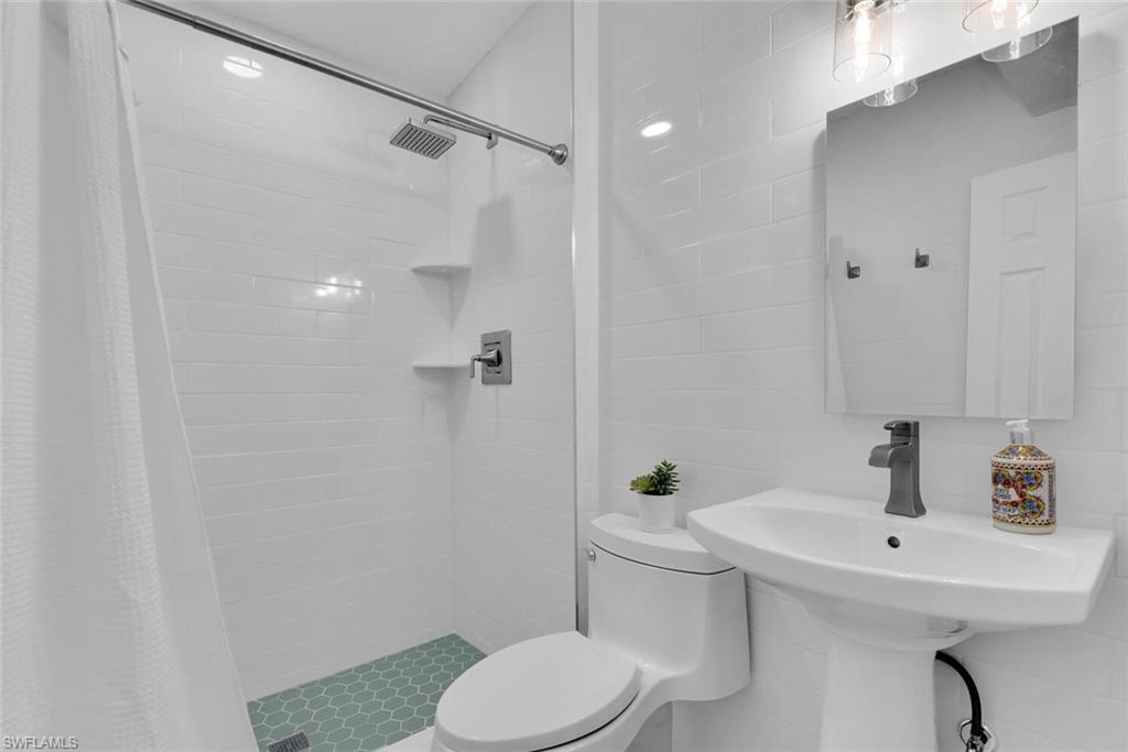 2048 Holiday Lane Naples, FL 34104 - Photo 15 of 28 a bathroom with a sink toilet and shower