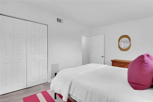 a bedroom with a bed and cabinets