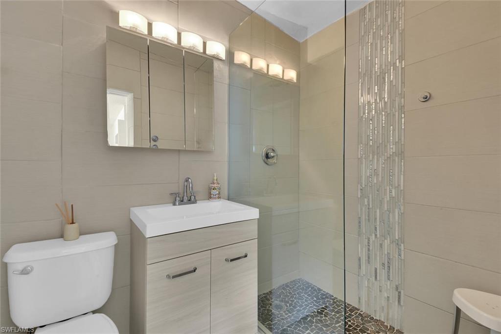 2048 Holiday Lane Naples, FL 34104 - Photo 23 of 28 a bathroom with a sink a toilet and shower