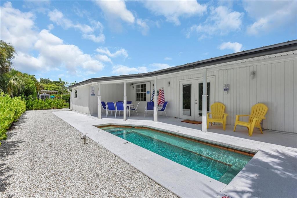 2048 Holiday Lane Naples, FL 34104 - Photo 27 of 28 a view of a house with backyard and sitting area