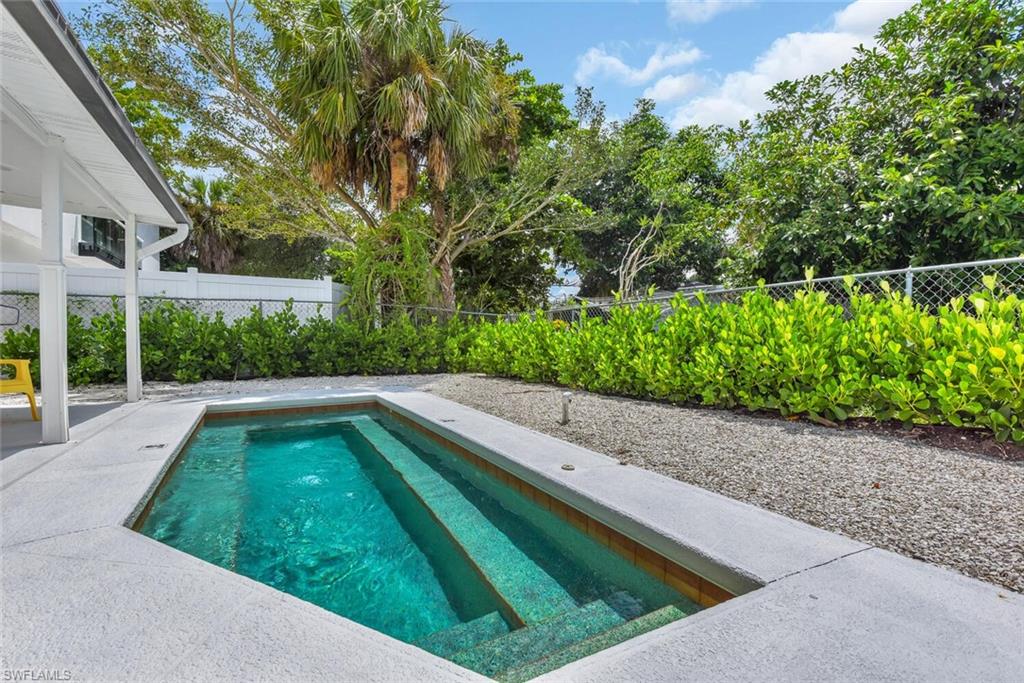 2048 Holiday Lane Naples, FL 34104 - Photo 28 of 28 a view of yard with swimming pool and green space