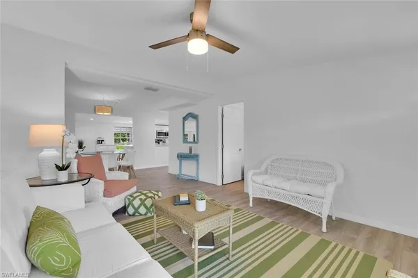 a living room with furniture and a lamp