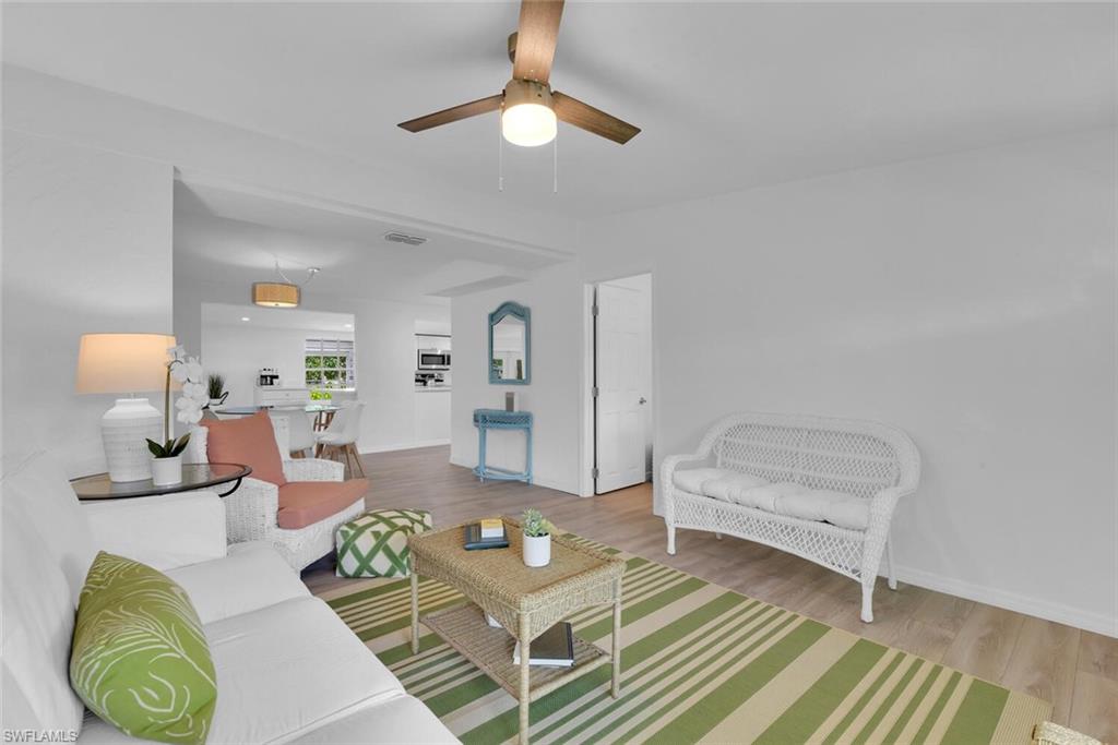 2048 Holiday Lane Naples, FL 34104 - Photo 4 of 28 a living room with furniture and a lamp