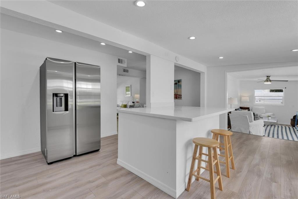 2048 Holiday Lane Naples, FL 34104 - Photo 9 of 28 a kitchen with kitchen island a counter top space and stainless steel appliances