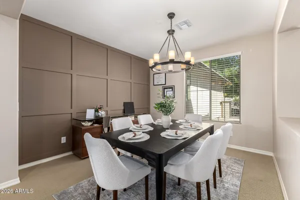 a view of a dining room with a table and chairs