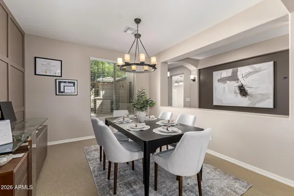 a dining room with furniture and window