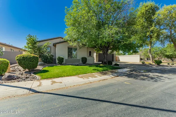 a front view of a house with a yard and a garage