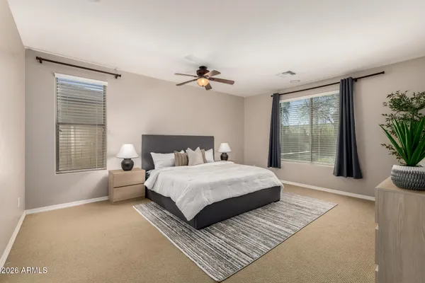 a bedroom with a large bed and a chandelier