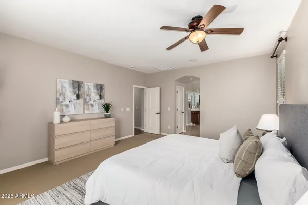 a bedroom with a bed and a chandelier