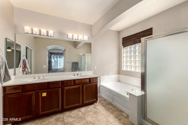 a bathroom with a tub sink and mirror