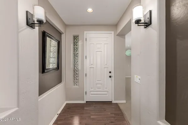 a view of a hallway with windows and stairs