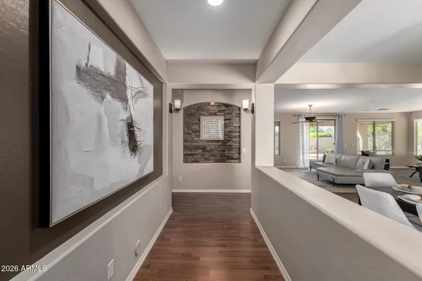 a view of a hallway with a couch and wooden floor
