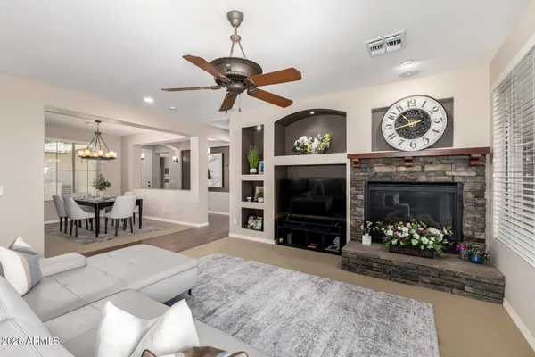 a living room with furniture a clock and a fireplace