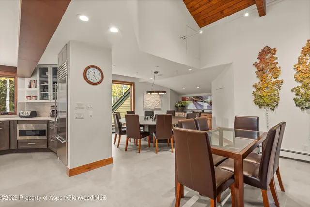 a room with furniture pool table flat screen tv and windows