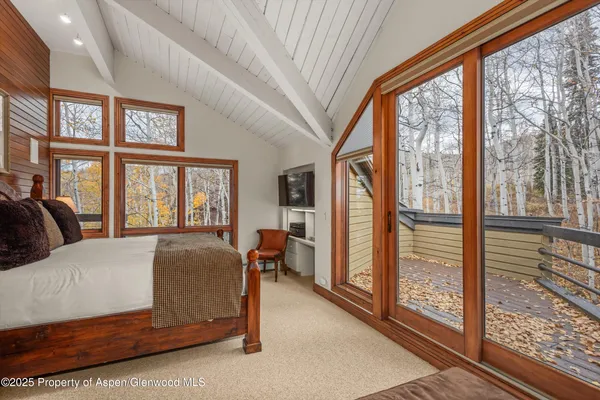 a bedroom with a large bed and a large window