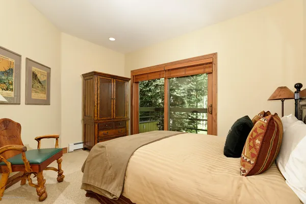 a bedroom with a bed and chair