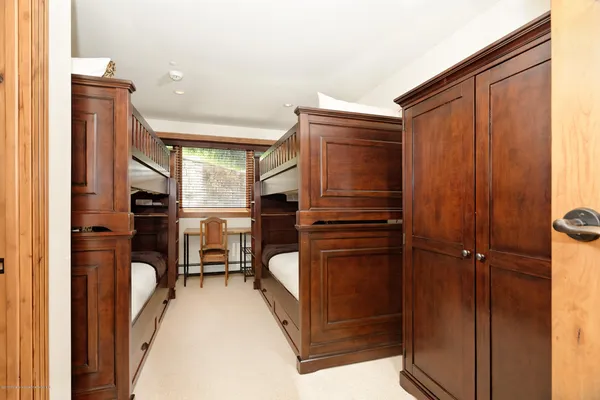 a room with pool table and windows