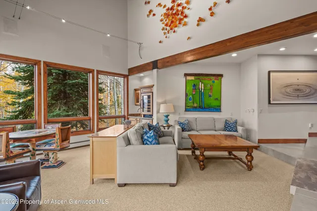 a dining room with furniture a fireplace and wooden floor