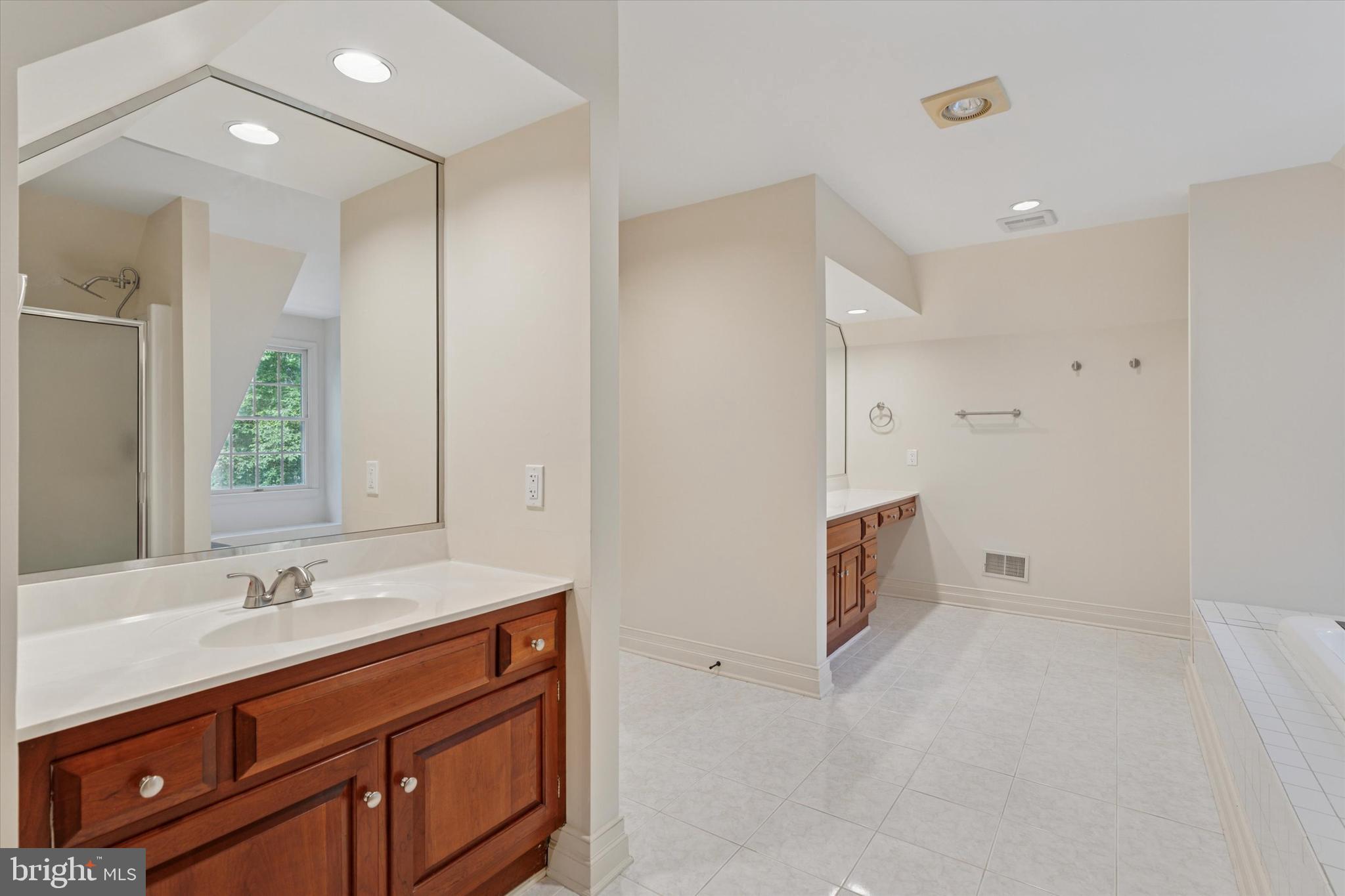 2824 Hill Road Green Lane, PA 18054 - Photo 17 of 40 a bathroom with double vanity sink and mirror