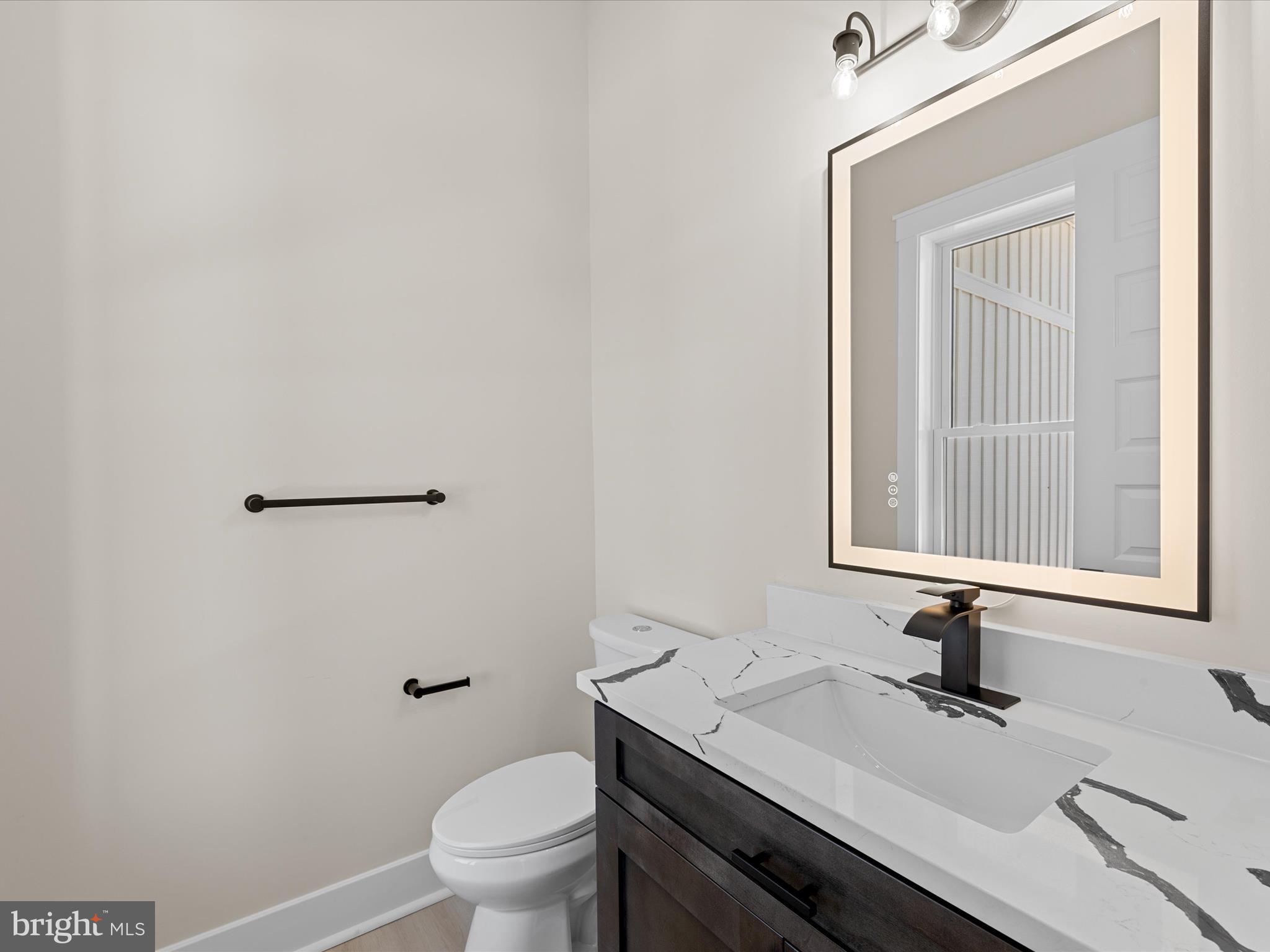 37000 Brittingham Road Delmar, DE 19940 - Photo 30 of 74 a bathroom with a sink a toilet and mirror