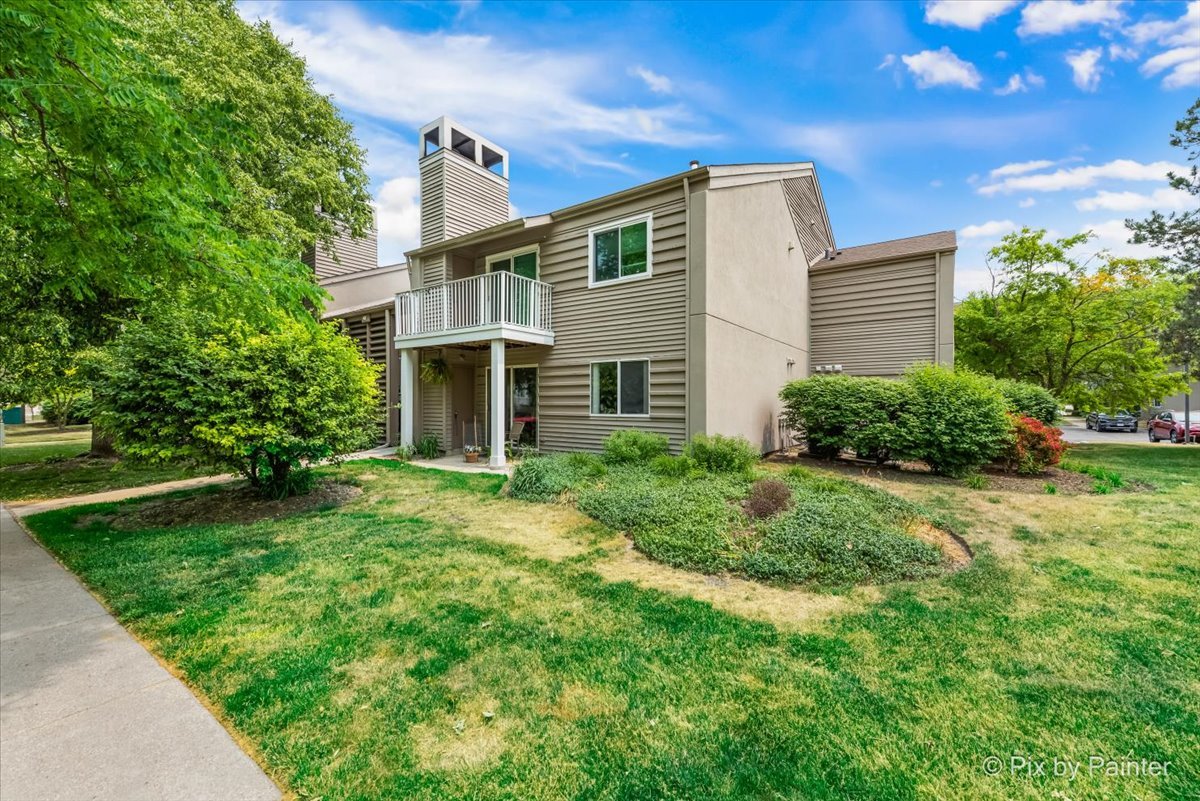 47 Orchard Terrace, Unit 8 Lombard, IL 60148 - Photo 2 of 16 a front view of a house with garden