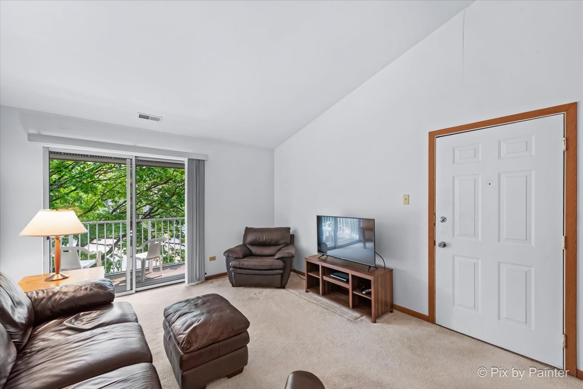 47 Orchard Terrace, Unit 8 Lombard, IL 60148 - Photo 3 of 16 a living room with furniture and a window