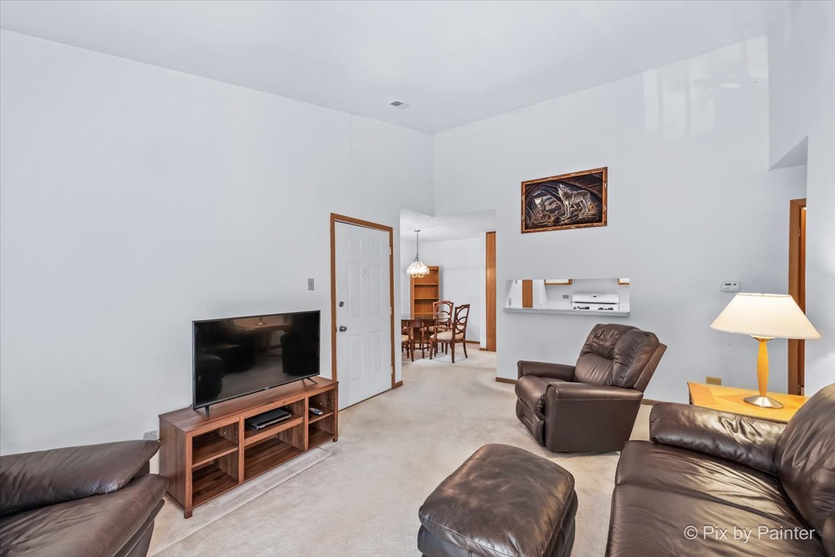 47 Orchard Terrace, Unit 8 Lombard, IL 60148 - Photo 4 of 16 a living room with furniture and a flat screen tv