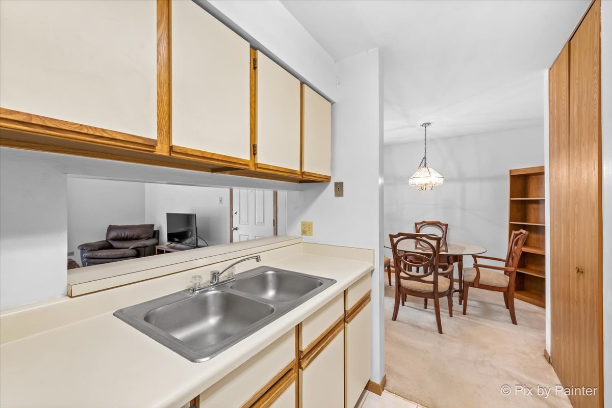 47 Orchard Terrace, Unit 8 Lombard, IL 60148 - Photo 9 of 16 a kitchen with a stove a sink and cabinets
