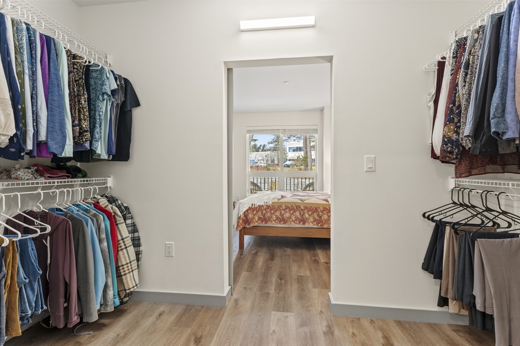 203 Lowell Street, Unit 103 Wilmington, MA 01887 - Photo 11 of 39 a view of walk in closet with clothes and shoes