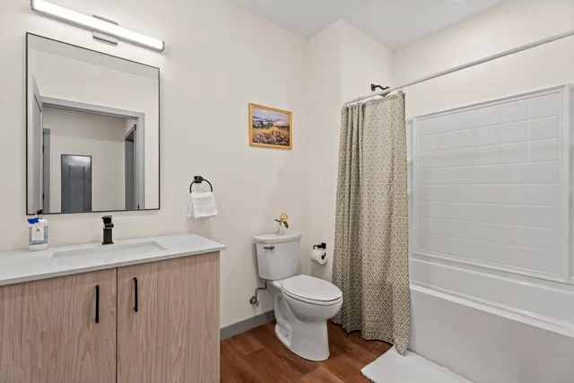 a bathroom with a sink toilet and shower