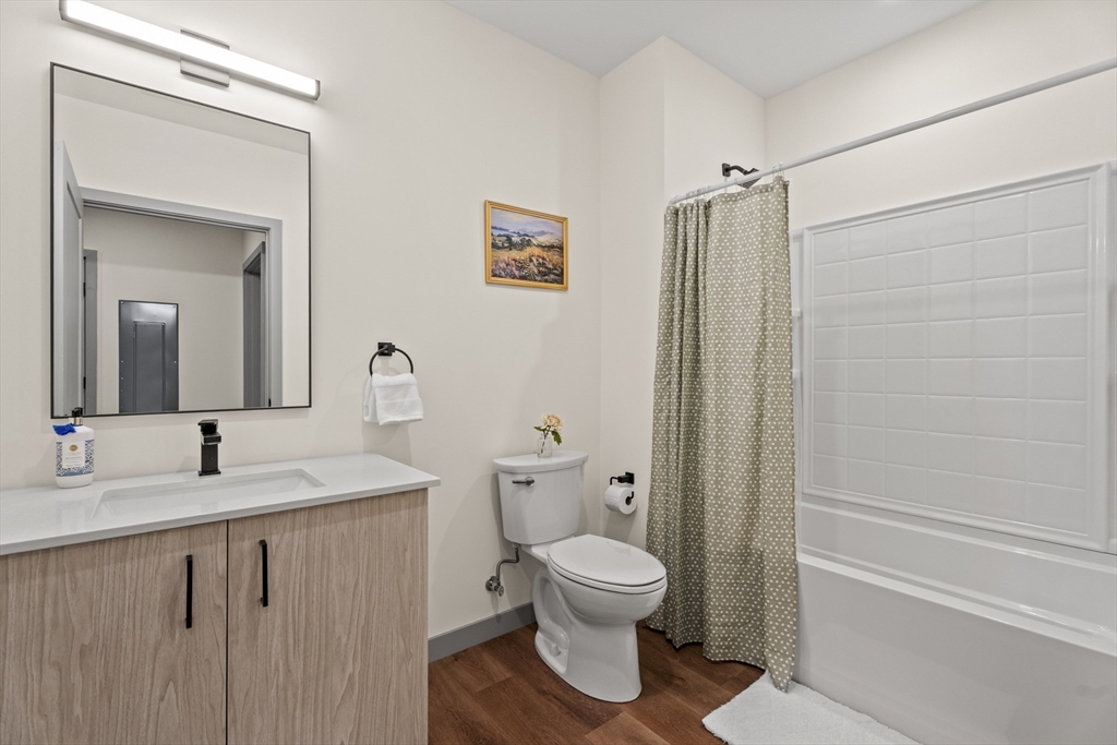 203 Lowell Street, Unit 103 Wilmington, MA 01887 - Photo 12 of 39 a bathroom with a sink toilet and shower