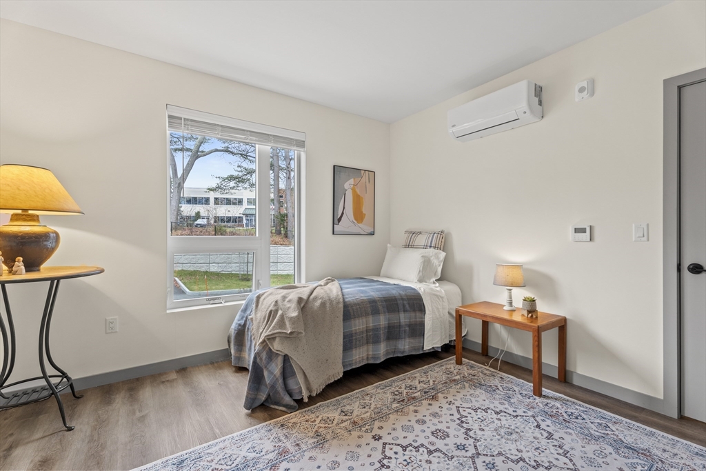 203 Lowell Street, Unit 103 Wilmington, MA 01887 - Photo 15 of 39 a bedroom with a bed and a window