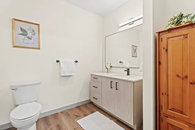a spacious bathroom with a toilet a sink and mirror