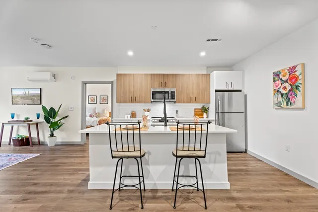 a view of a kitchen with dining table and chairs