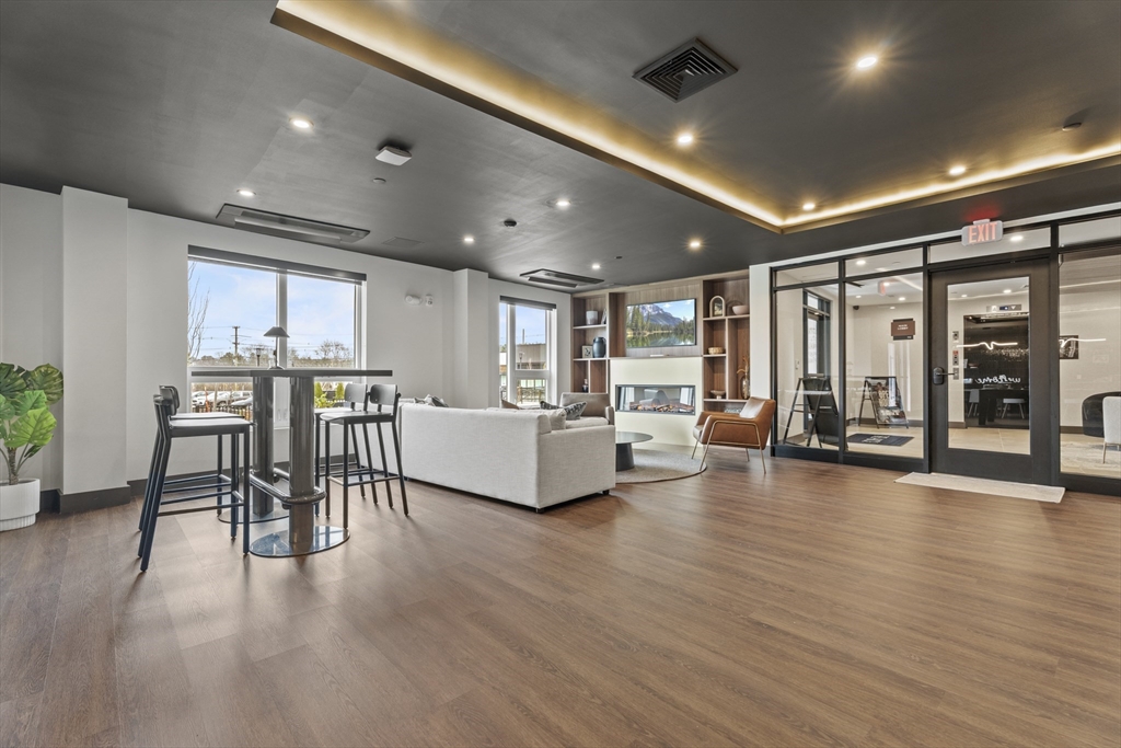 203 Lowell Street, Unit 103 Wilmington, MA 01887 - Photo 21 of 39 a living room with furniture and a table