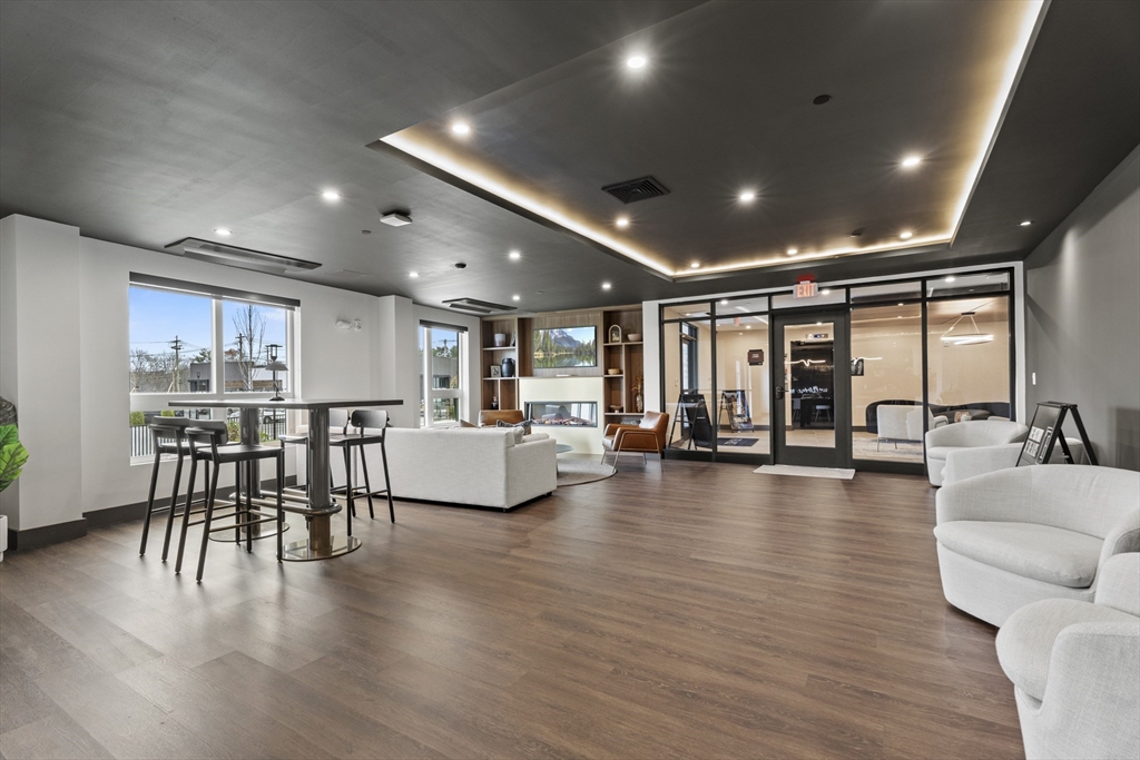 203 Lowell Street, Unit 103 Wilmington, MA 01887 - Photo 22 of 39 a view of a dining room with furniture and wooden floor