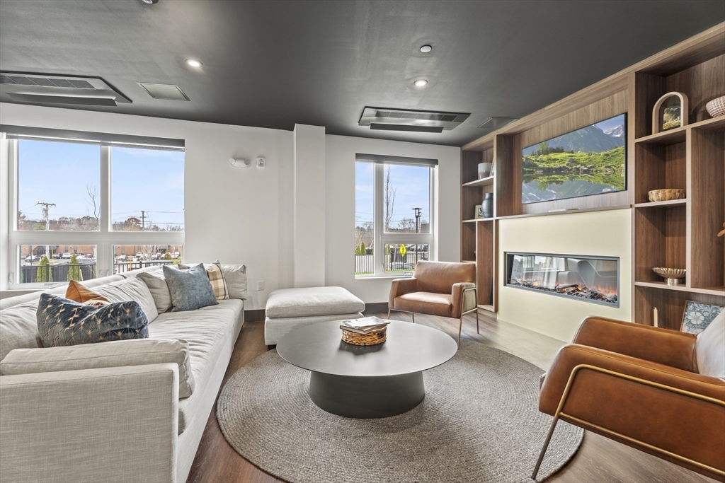 203 Lowell Street, Unit 103 Wilmington, MA 01887 - Photo 23 of 39 a living room with furniture and a large window