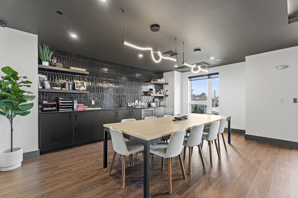 203 Lowell Street, Unit 103 Wilmington, MA 01887 - Photo 26 of 39 a kitchen with a table and chairs in it